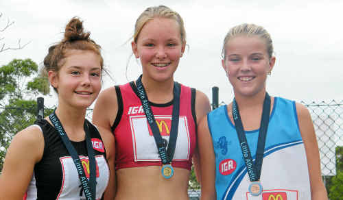 Emma Robson stands proudly on the dais with her gold medal won in the under-15 1500m walk. Emma Robson stands proudly on the dais with her gold medal won in the under-15 1500m walk.